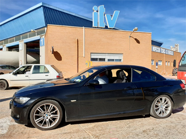 BMW 330i Cabrio awaits it's import test at ITV station in Murcia BMW 330i below ITV sign